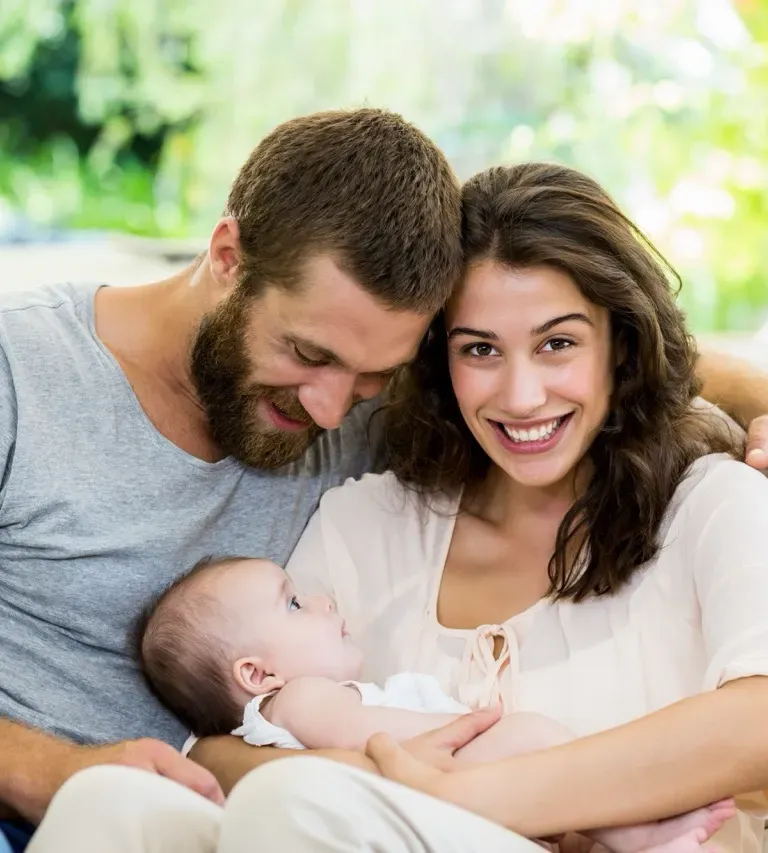 Happy family playing outdoors, parents with child in nature